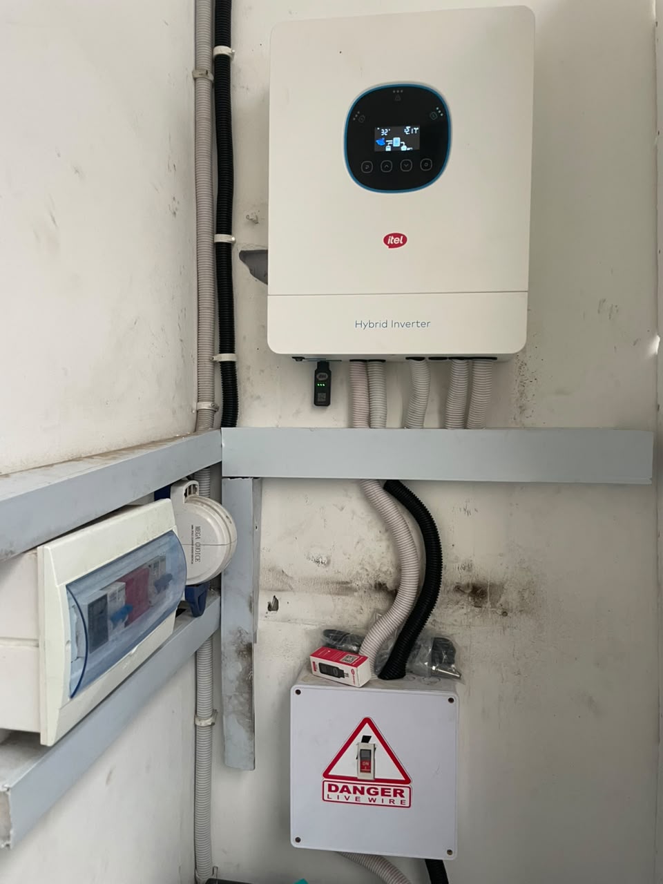 Hybrid inverter installed next to a distribution board and protection enclosure