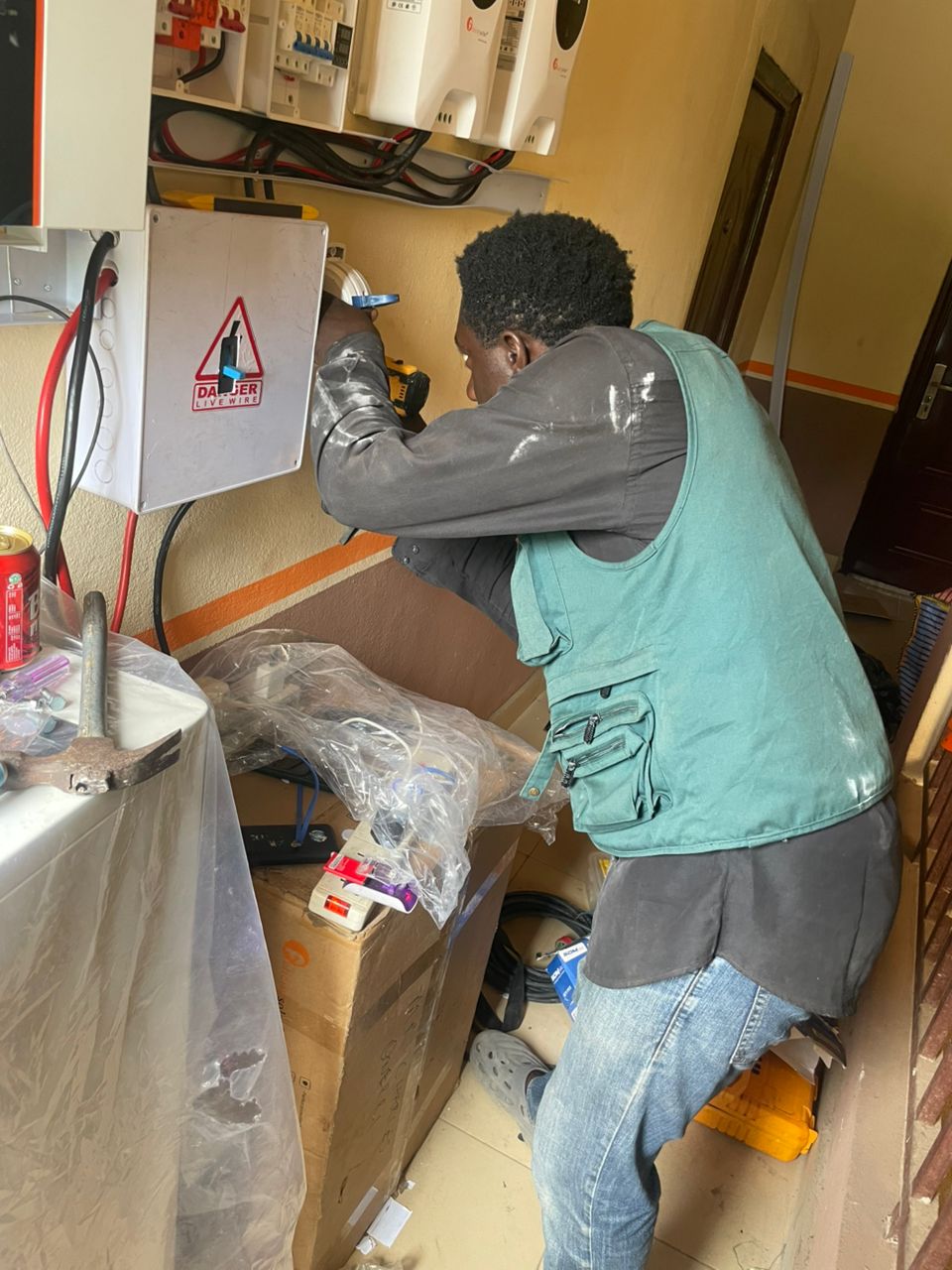 Chukwuma Olowa working on a solar inverter installation